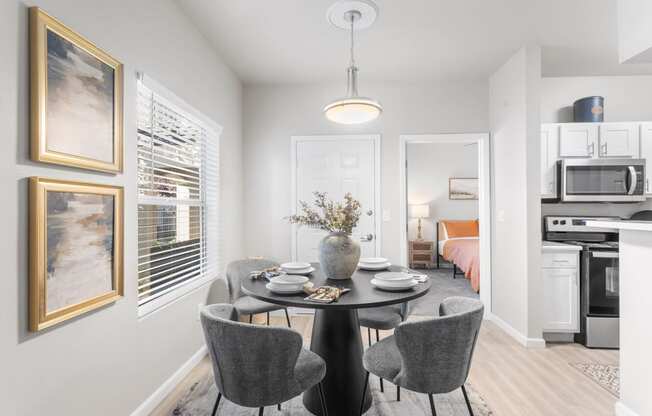 a dining room with a table and chairs