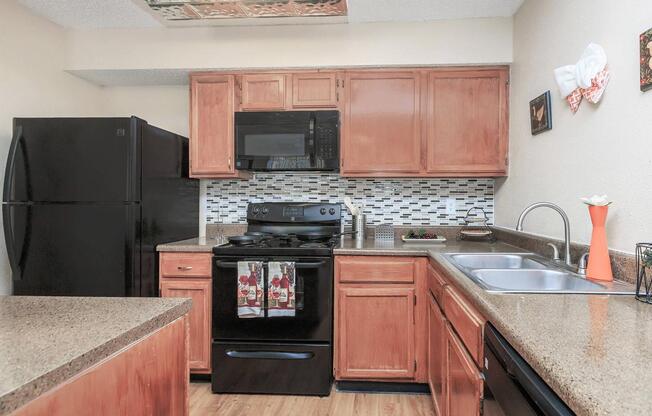 a kitchen with stainless steel appliances and wooden cabinets