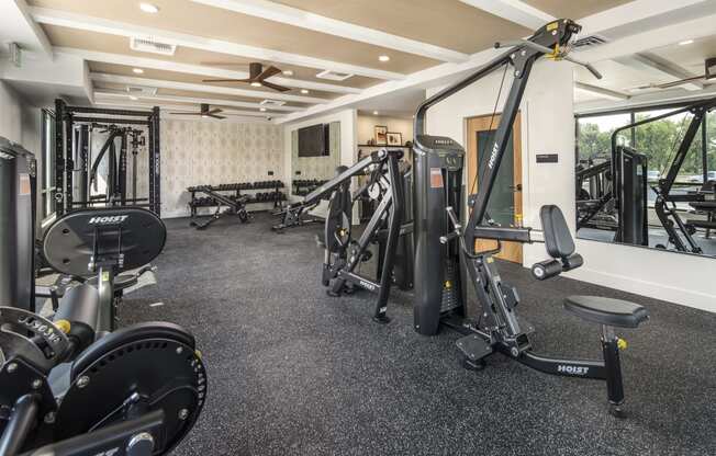 a gym with weights and other exercise equipment on the floor