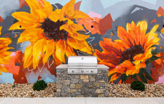 a mailbox in front of a mural of sunflowers