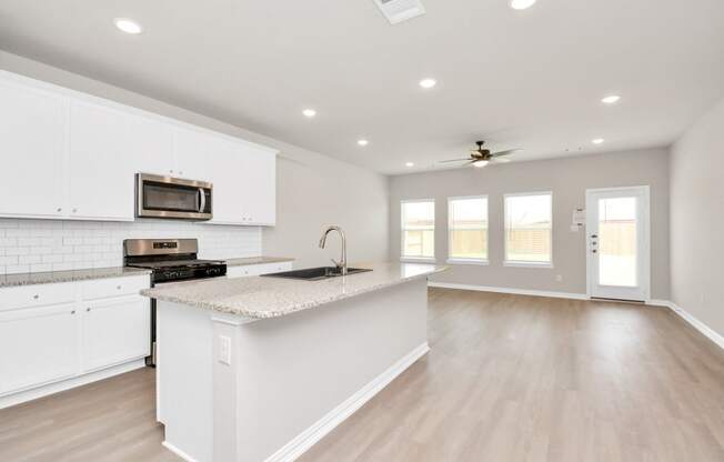 a kitchen with white cabinets and a white counter top