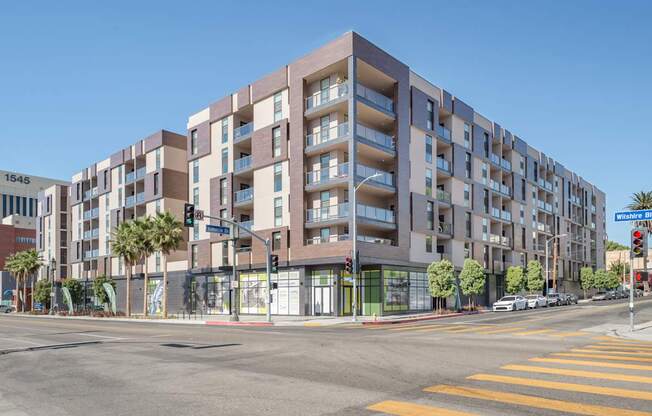 A modern apartment building with a street view in front.