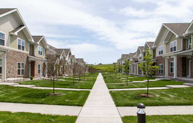 A long walkway leads between two rows of houses.