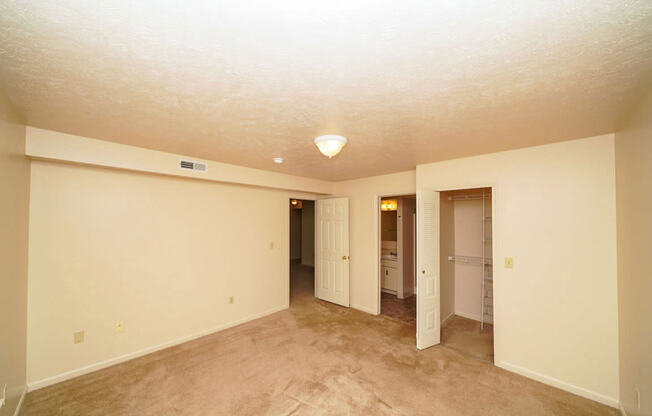 A spacious bedroom with an attached bath and walk in closet at Foxwood and The Hermitage, Portage, MI