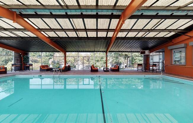 A large indoor swimming pool with a glass bottom.