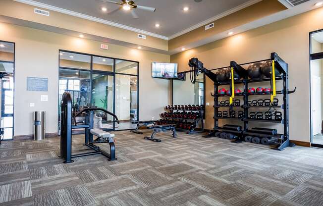 the preserve at ballantyne commons fitness room with weights and a tv