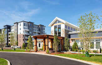 an exterior view of a building with trees and a road