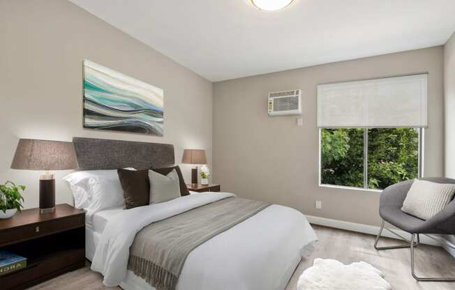 Bedroom with wood-inspired floors, sliding window