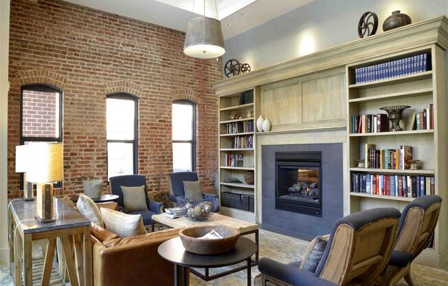 a living room with a brick wall and a fireplace