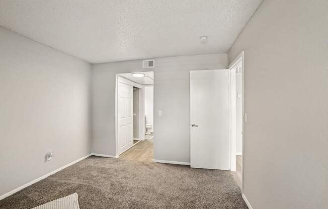 A room with a carpeted floor and white walls.