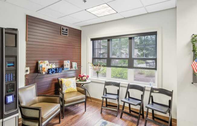 a conference room with chairs and a table and a large window