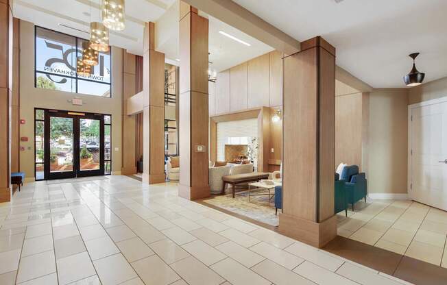 A large, open living room with a white tile floor and a glass door leading to a balcony.