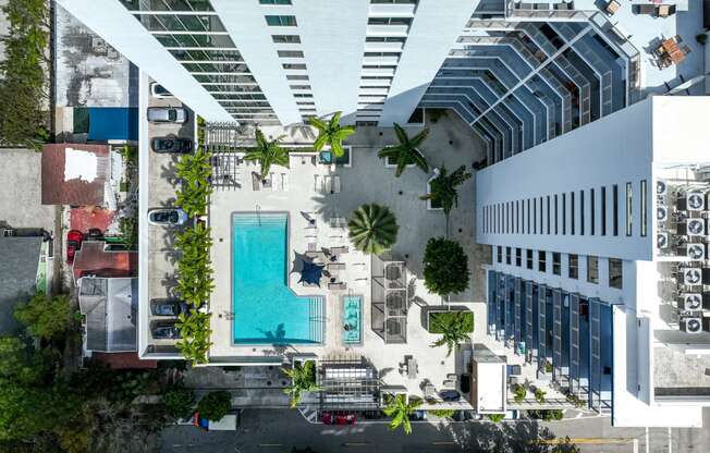 a rendering of a building with a pool and a parking lot