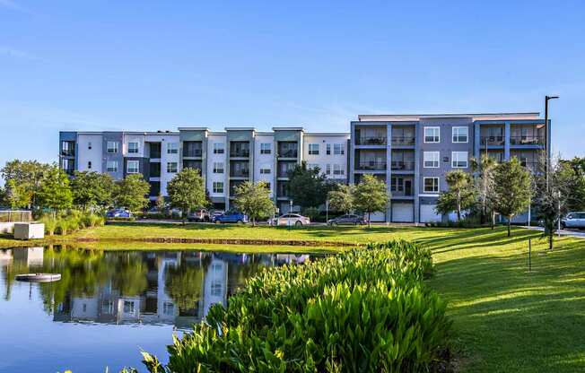 a large pond in front of an apartment building