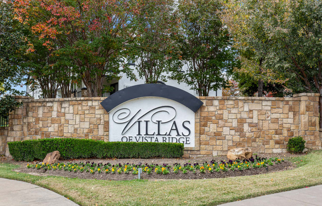 the villas sign at the entrance to the villa