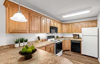 a kitchen with wooden cabinets and a granite counter top