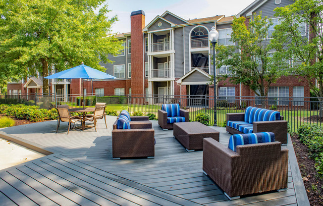 our apartments showcase a large deck with lounge chairs and a fire pit at Lincoln at Wolfchase, Cordova Tennessee