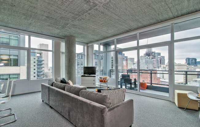 a living room with a couch and a view of the city