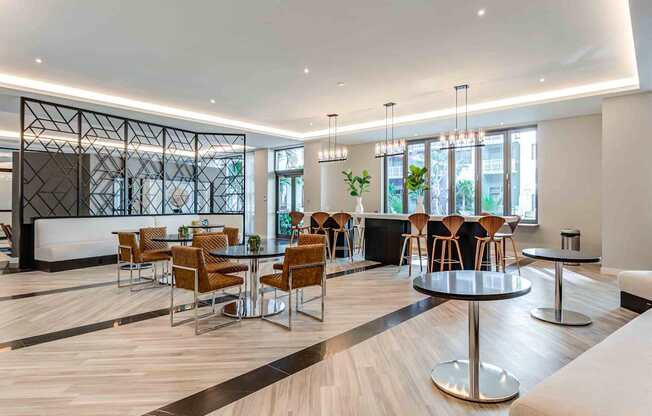 A modern dining area with wooden floors and a mix of round and square tables.