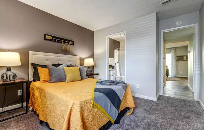 Bedroom with a bed and a door to a bathroom  at Union Heights Apartments, Colorado Springs, CO