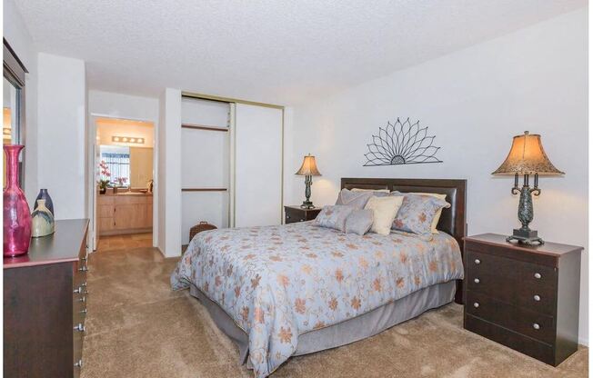 a bedroom with a bed and a dresser at Riverview Springs, Oceanside