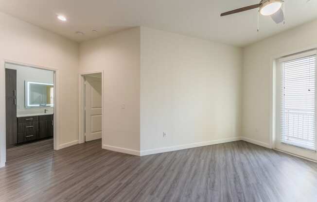 Beautiful Bright Bedroom with hardwood floors and a ceiling fan at Residences at 3000 Bardin Road, Grand Prairie, TX