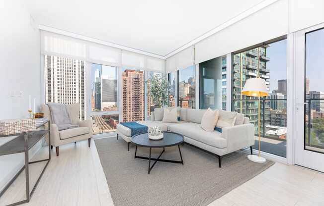 a living area with a couch coffee table and large windows