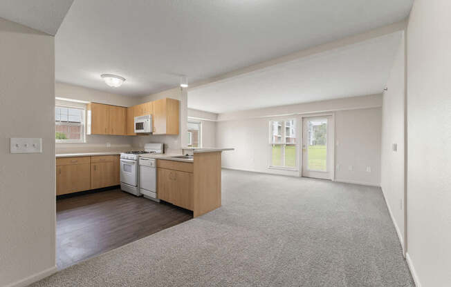 A kitchen with wooden cabinets and a white dishwasher at Stoney Pointe Apartment Homes, Kansas