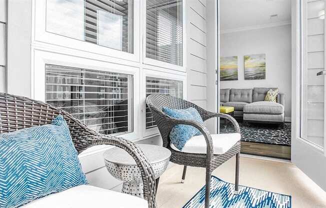 a living room with two chairs and a window