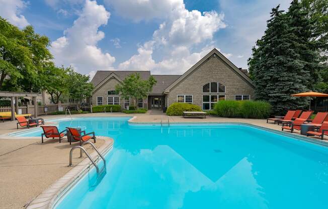 a swimming pool with a house in the background