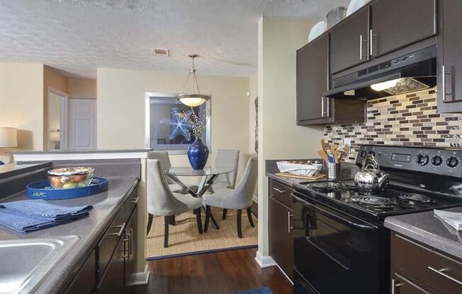 kitchen with black appliances at Harvard Place Apartments, Lithonia, GA, 30058