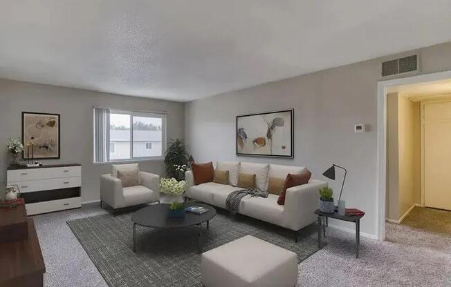 A living room with a white couch, a coffee table, and a grey rug.