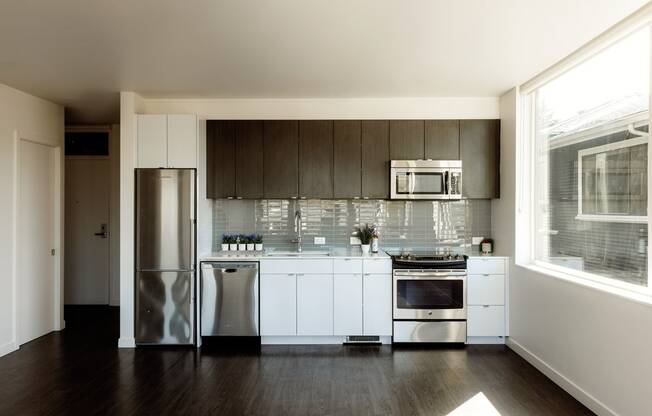 a kitchen with white cabinets and stainless steel appliances
