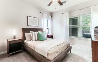 a bedroom with a bed and a ceiling fan