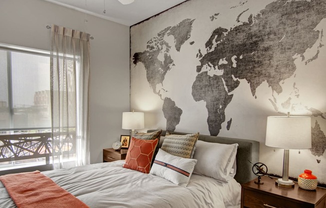 a bedroom with a bed and a world map on the wall