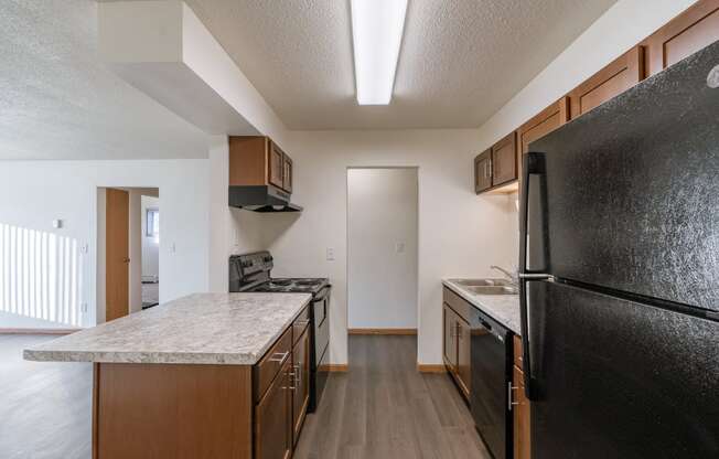 a kitchen and living room. Fargo, ND North Manor Apartments