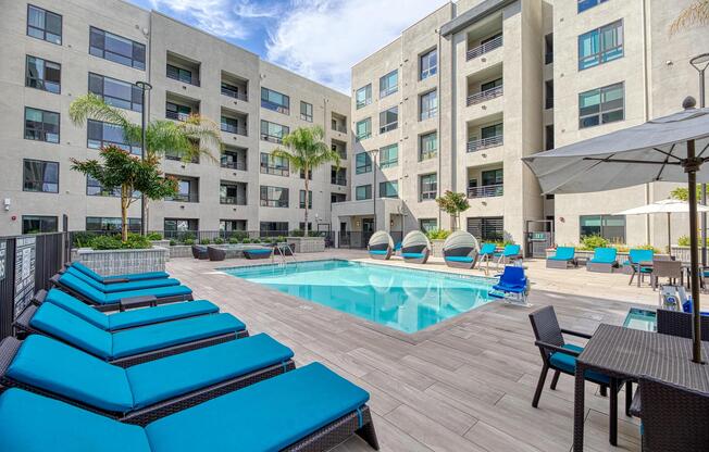 Open pool area with vibrant loungers, shaded spots, and nearby outdoor kitchens for easy enjoyment.