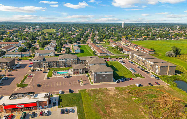 A view of a town from above with a large building in the foreground.