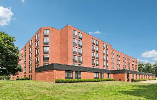 A red brick building with a black base and windows on the side.