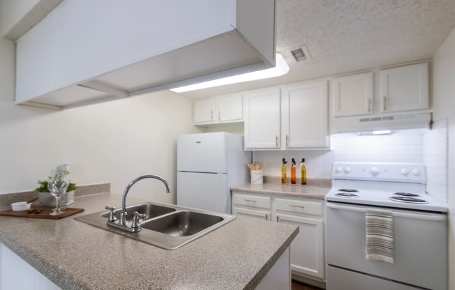 This is a photo of the kitchen in the 871 square foot 2 bedroom, 2 bath apartment at Princeton Court Apartments in the Vickery Meadow neighborhood of Dallas, Texas.