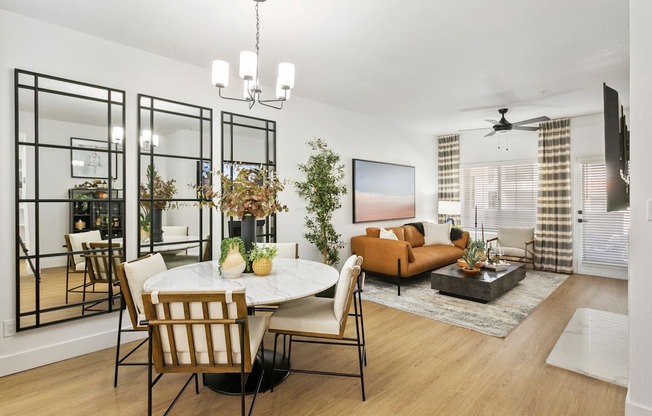 a living room and dining room with a table and chairs