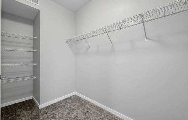 a closet in a white room with a mirrored closet door