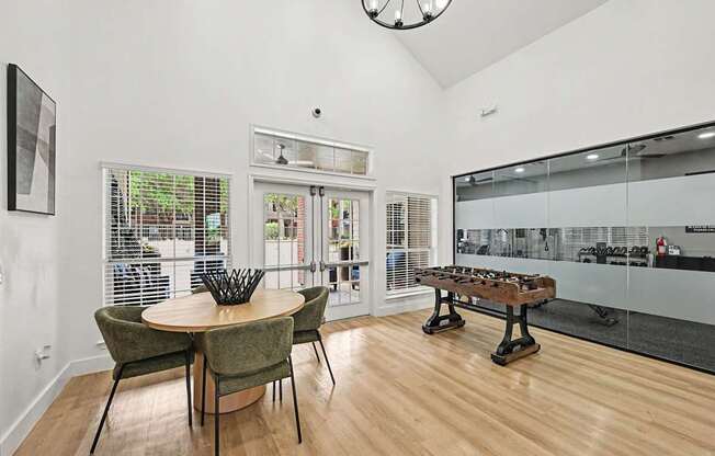 A dining room with a round table and chairs.