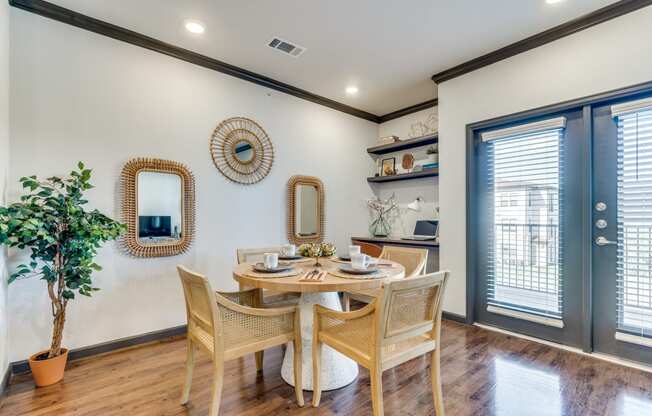 a dining room with a table and chairs and a window