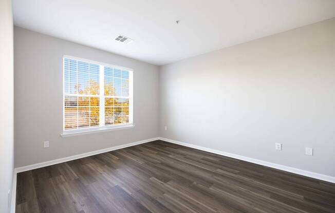 A room with a window showing trees outside. at Harbor Pointe, Bayonne, NJ, 07002