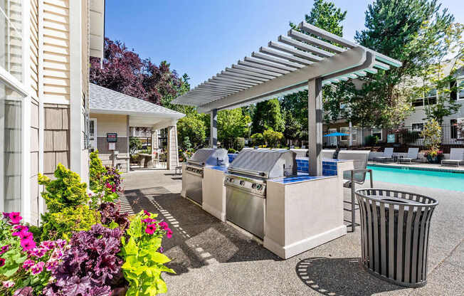 A poolside area with a trash can and a trash can cover.