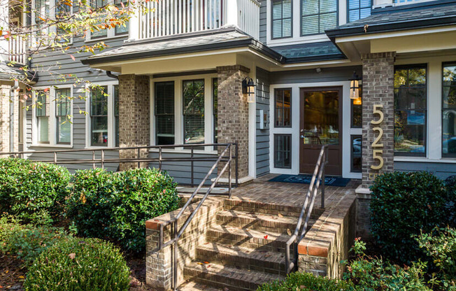 A house numbered 525 with a front porch and steps leading up to the entrance.