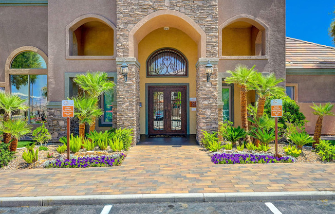 A building with a brown door and a sign in front of it.