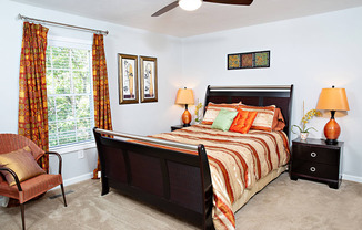 a bedroom with a bed and a ceiling fan