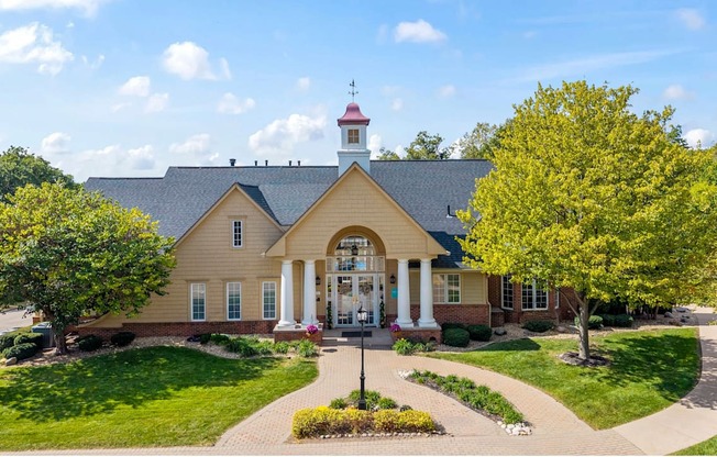 A house with a red roof and a white columned porch.